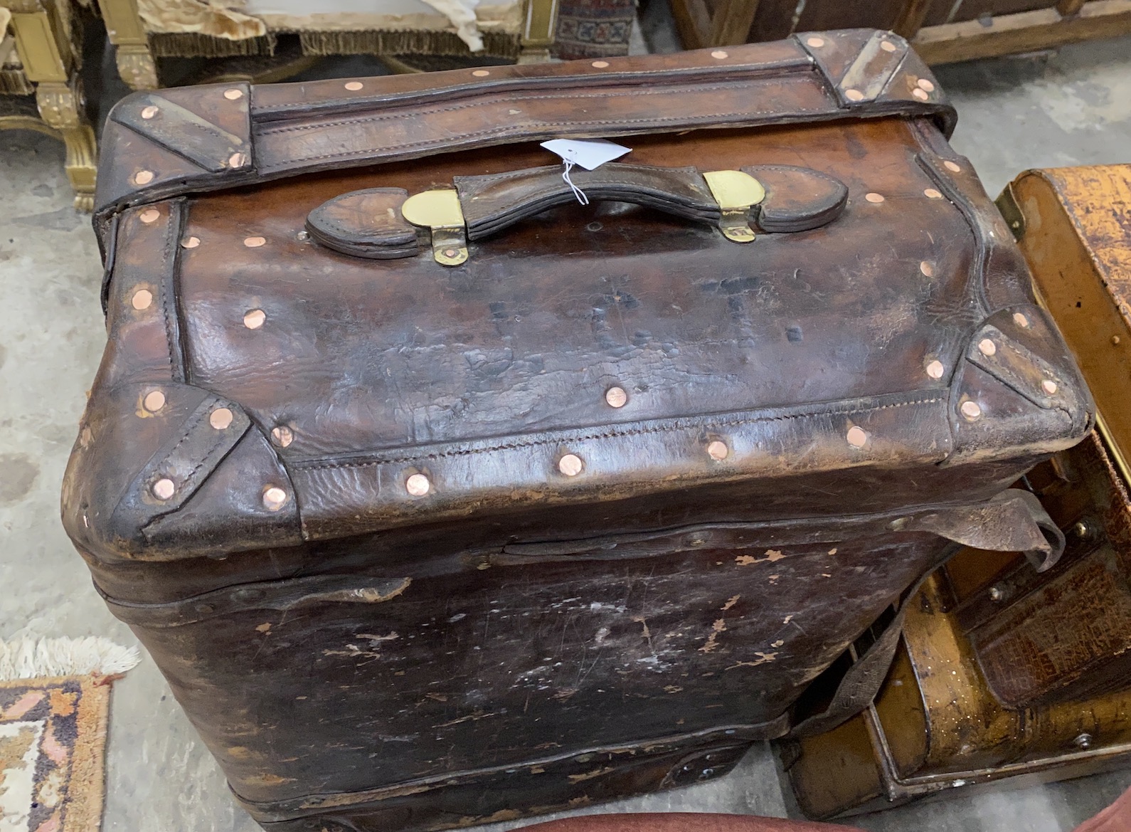 A Victorian leather copper and brass studded travelling trunk, length 94cm, depth 56cm, height 30cm